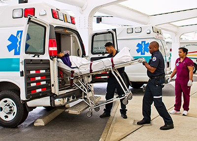 BHB emergency services team loading a patient into an ambulance