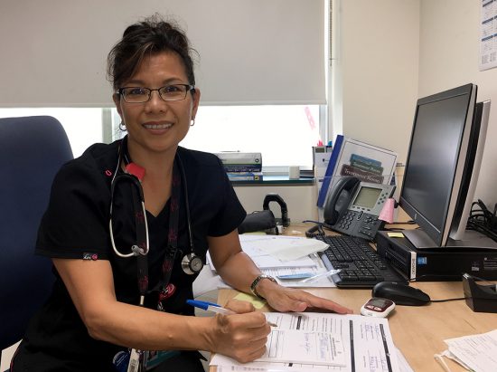 Nurse Practitioner Myrian Balitian-Dill at her desk