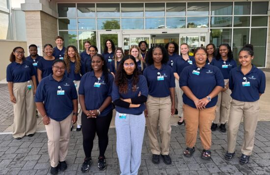 Group photo of BHB summer students outside the Acute Care Wing lobby doors